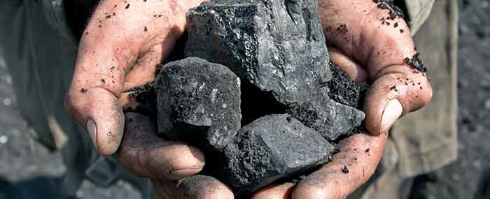 hands holding coal