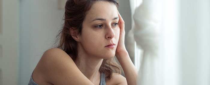 worried woman staring out the window