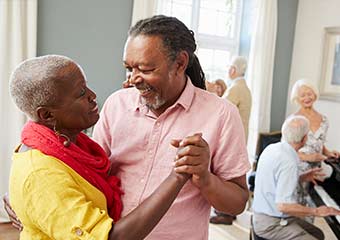 happy elderly couple dancing