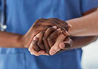 doctor holding hands with patient